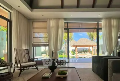 Luxurious living room with stunning poolside view and elegant decor