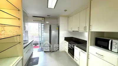 Modern kitchen with sleek cabinetry, stainless steel appliances, and ample natural light.