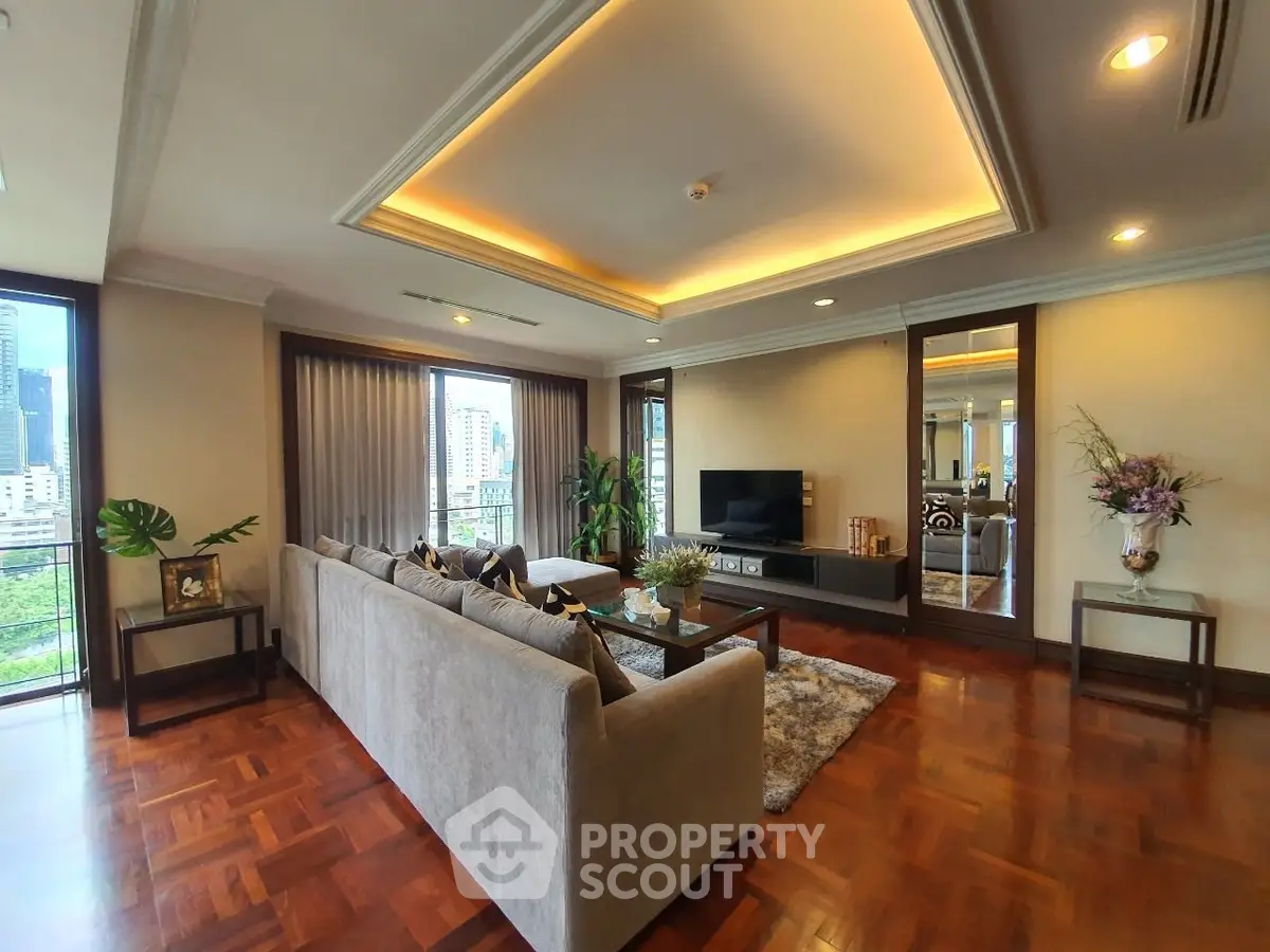 Luxurious living room with elegant decor and city view, featuring a spacious sofa and modern entertainment center.