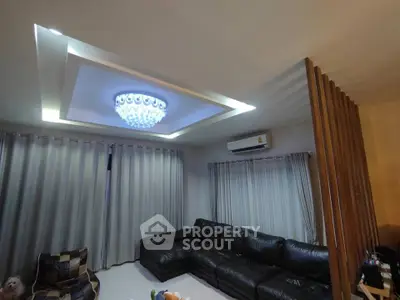 Luxurious living room with elegant chandelier and modern leather sofa