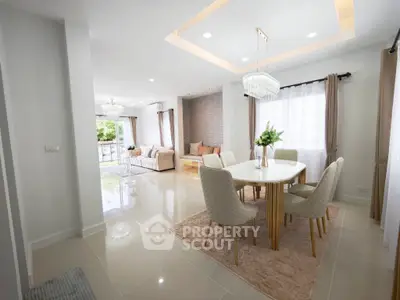 Spacious modern living and dining area with elegant decor and natural light.
