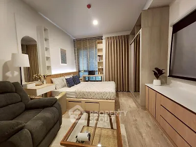 Modern studio apartment with cozy living area and stylish decor