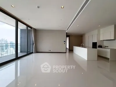 Spacious modern living room with open kitchen and city view balcony