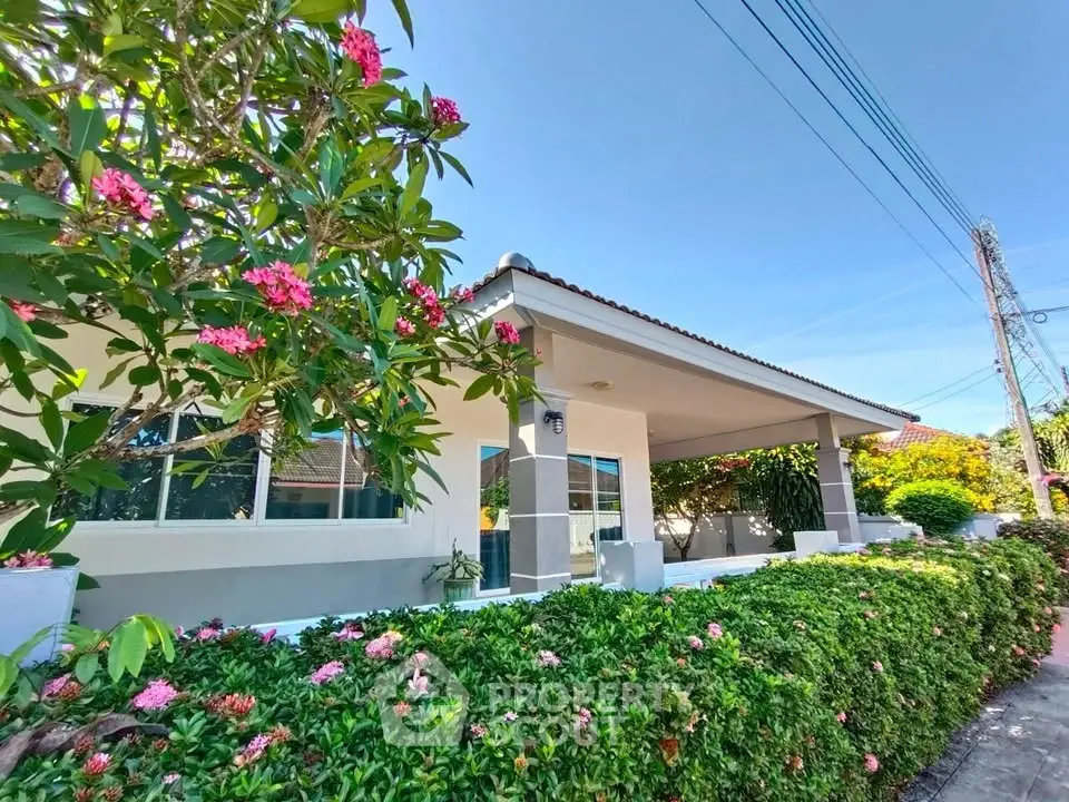 Charming single-story home with lush garden and vibrant flowers, perfect for serene living.