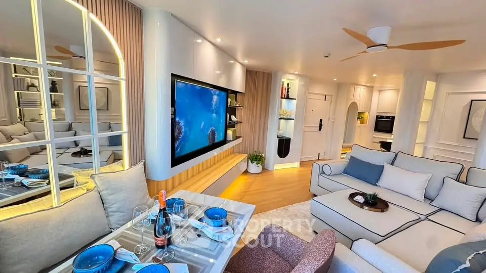 Luxurious modern living room with elegant decor and large wall-mounted TV