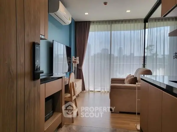 Modern living room with large windows and stylish decor in a cozy apartment.