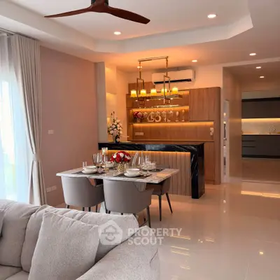Luxurious open-plan living and dining area with modern kitchen and elegant decor.