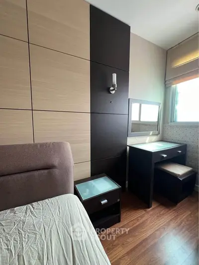Modern bedroom with stylish wood paneling and natural light