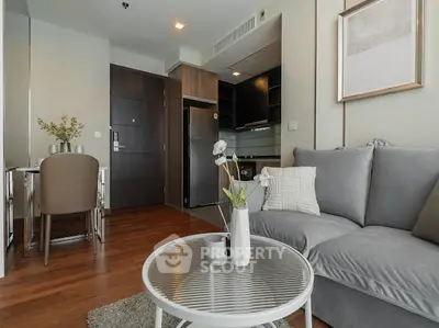 Modern living room with cozy gray sofa and stylish decor in a contemporary apartment.