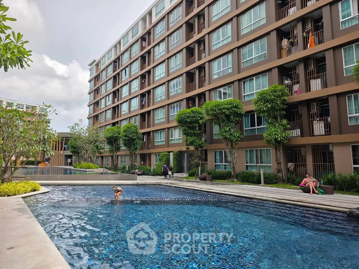 Modern apartment complex with inviting outdoor pool and lush greenery
