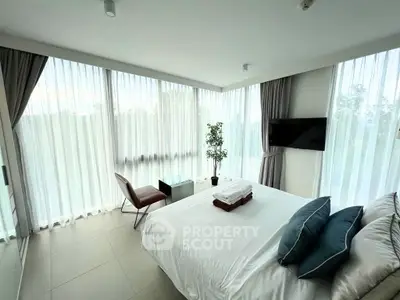 Luxurious bedroom with floor-to-ceiling windows and modern decor