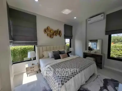 Luxurious bedroom with elegant decor and large windows offering garden views