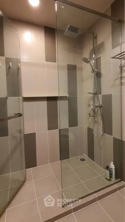 Modern bathroom with glass shower enclosure and stylish tile design