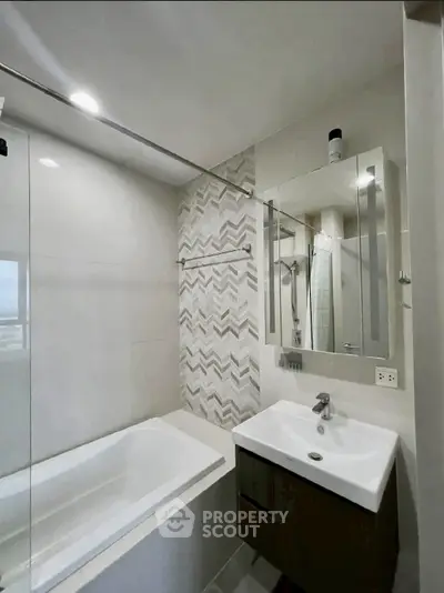 Modern bathroom with bathtub and stylish tile design