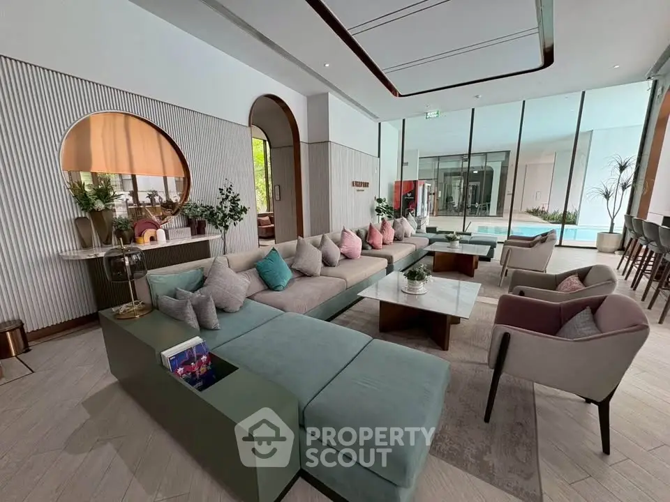 Luxurious modern living room with stylish decor and pool view, perfect for relaxation and entertainment.