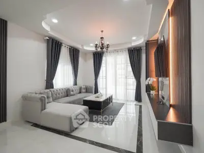 Luxurious modern living room with elegant chandelier and plush sectional sofa
