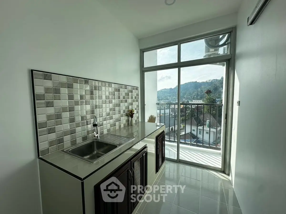 Modern kitchen with scenic balcony view in a stylish apartment