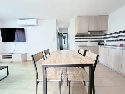 Modern open-plan living room and kitchen with sleek furniture and stylish decor.
