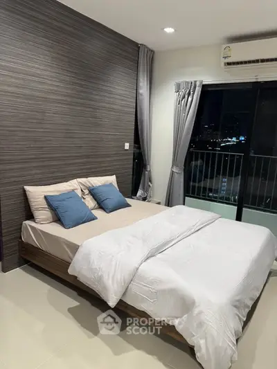 Modern bedroom with city view and stylish decor, featuring a comfortable bed and elegant curtains.