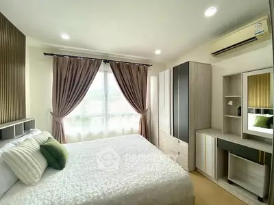 Spacious bedroom with modern decor and ample natural light