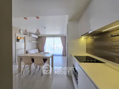 Modern open-layout kitchen and dining area with sleek design and natural light.