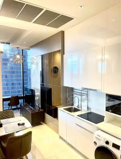 Modern open-plan kitchen and living area with city view, featuring sleek appliances and stylish decor.