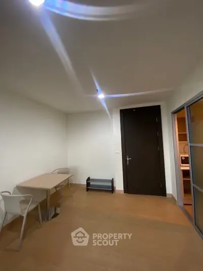 Minimalist interior with wooden flooring and modern furniture in a cozy apartment.