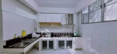 Spacious kitchen with modern appliances and ample counter space.