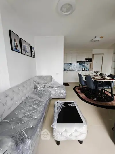 Modern living room with stylish furniture and open kitchen layout