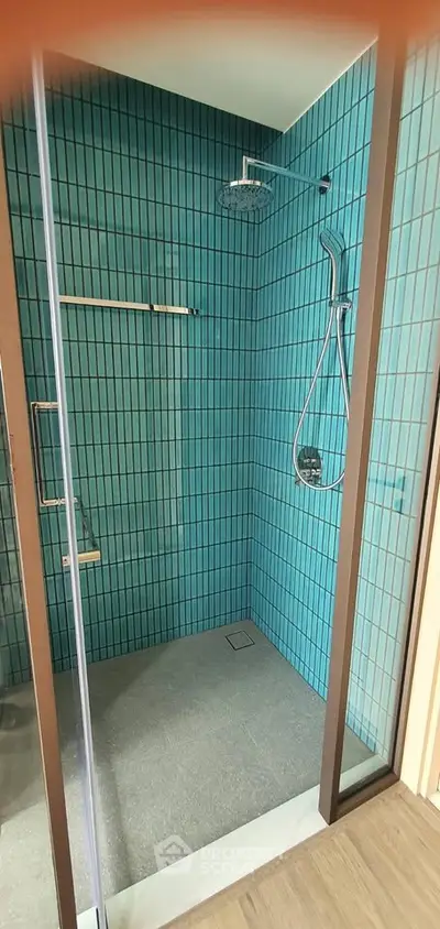 Modern bathroom with stylish blue tile shower and glass door