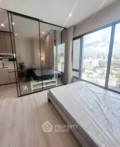 Modern bedroom with city view and glass partitioned study area