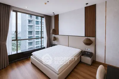 Luxurious bedroom with floor-to-ceiling windows offering stunning city views in a modern high-rise apartment.