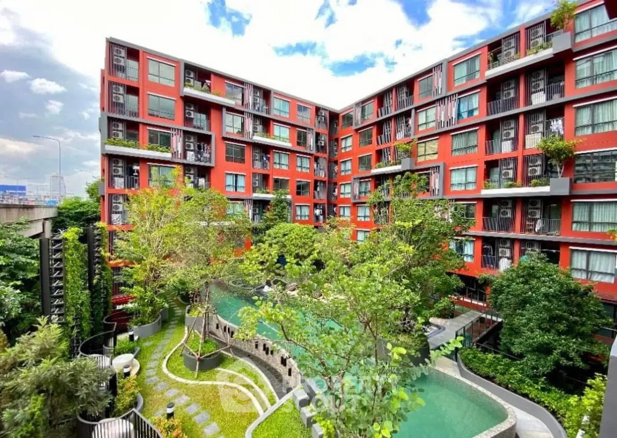 Stunning modern apartment complex with lush garden and pool view