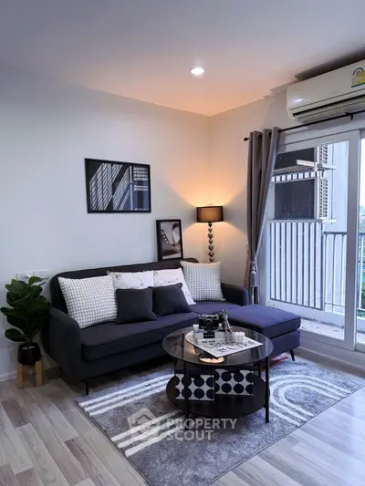 Modern living room with stylish decor and balcony view