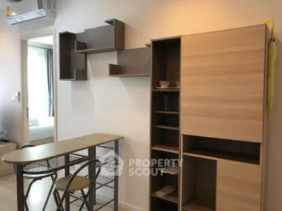 Modern apartment interior with stylish shelving and compact dining area