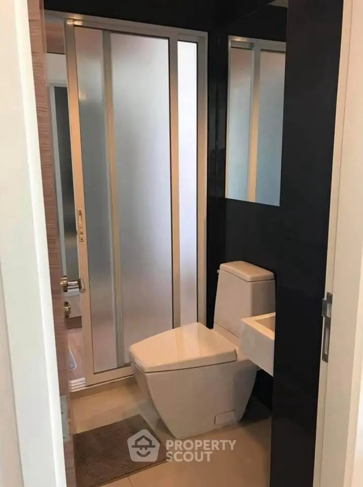 Modern bathroom with sleek design and frosted glass shower door
