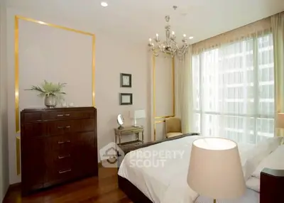 Elegant bedroom with chandelier and large window in modern apartment