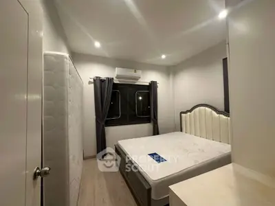 Cozy bedroom with modern furnishings and air conditioning, perfect for restful nights.