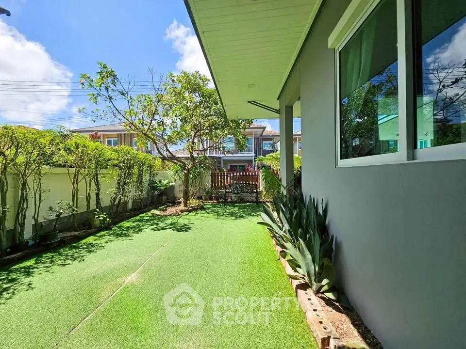 Charming backyard with lush greenery and modern exterior, perfect for relaxation.