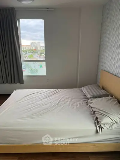 Cozy bedroom with natural light and modern decor, perfect for relaxation and comfort.
