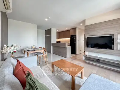 Modern open-plan living room with stylish kitchen and cozy seating area