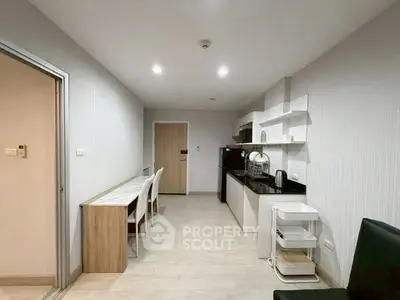 Modern kitchen with sleek design and open layout, featuring a breakfast bar and contemporary appliances.