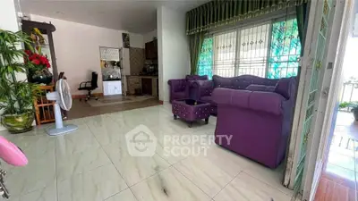 Spacious living room with vibrant purple furniture and open layout, perfect for modern living.