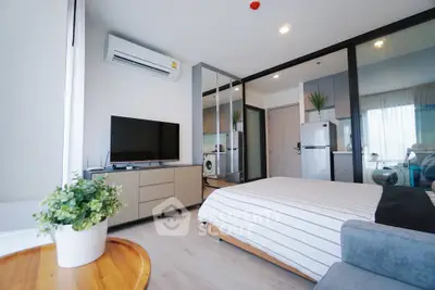 Modern bedroom with sleek design, featuring a TV, air conditioning, and mirrored wardrobe in a stylish apartment.
