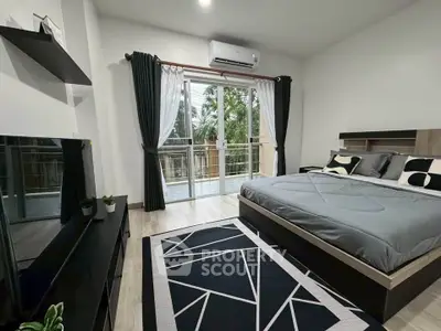 Modern bedroom with balcony view, stylish decor, and natural light