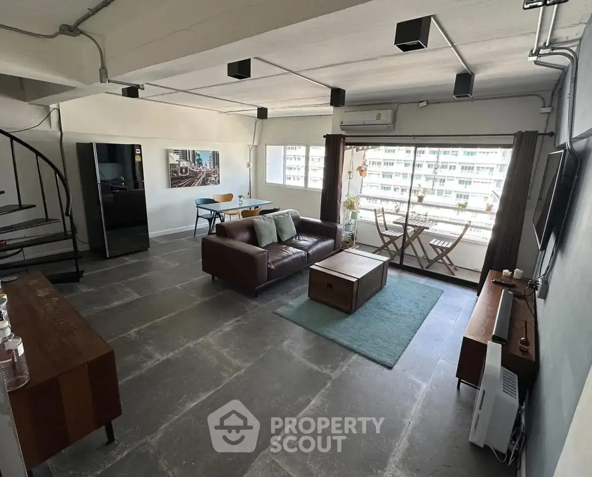 Spacious modern living room with balcony and stylish decor in urban apartment