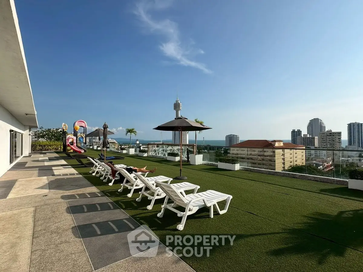 Stunning rooftop terrace with lounge chairs and city views, perfect for relaxation and leisure.