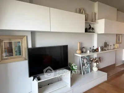 Modern living room with sleek white shelving and mounted TV