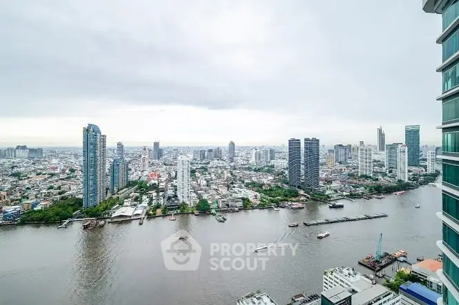 Stunning cityscape view from high-rise building overlooking river and skyline.