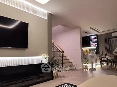 Modern living room with stylish decor and open staircase